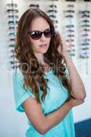 Pretty woman shopping for sunglasses