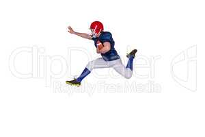 American football player jumping with the ball