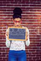 A beautiful hipster holding a blackboard