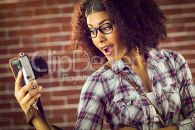 Attractive hipster taking selfies with camera