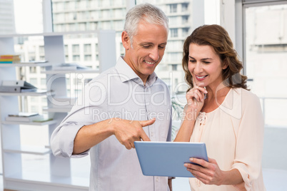 Casual business colleagues working with tablet