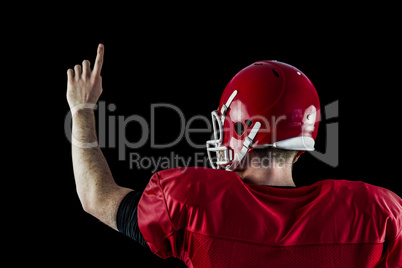 Rear view of american football player triumphing