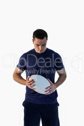 Attentive man holding a rugby ball