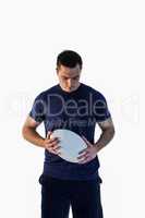 Attentive man holding a rugby ball