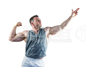 Handsome bodybuilder posing with arms up