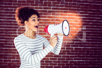 Young woman using her megaphone in the light