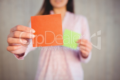 Woman holding green and orange cards