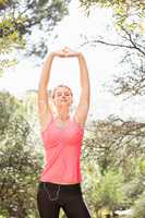 Blonde athlete stretching arms