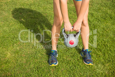 Sporty woman exercising with kettlebell