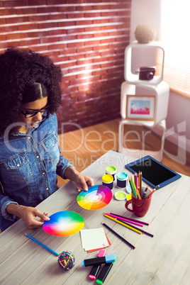 Casual businesswoman holding a color wheel