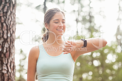 Happy jogger looking at watch