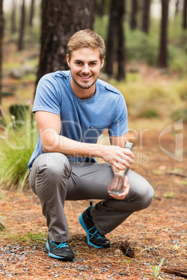 Portrait of a handsome man holding a water bottle