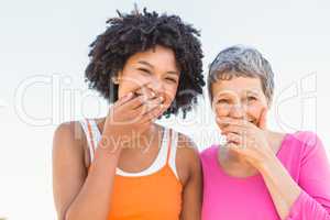 Two sporty women laughing to camera