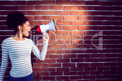 Young woman using her megaphone in the light