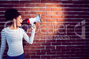 Young woman using her megaphone in the light