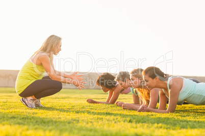 Sporty women planking during fitness class