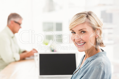 Smiling businesswoman working on a laptop