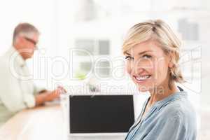 Smiling businesswoman working on a laptop