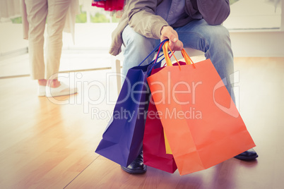 Man waiting for his shopping woman