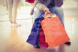 Man waiting for his shopping woman