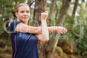 Athletic blonde stretching arms