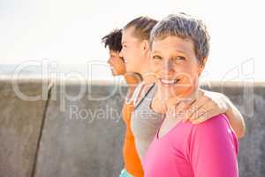 Smiling sporty woman with two friends