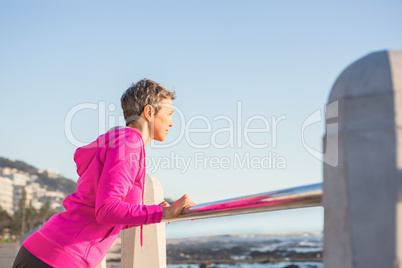 Sporty woman stretching on railing