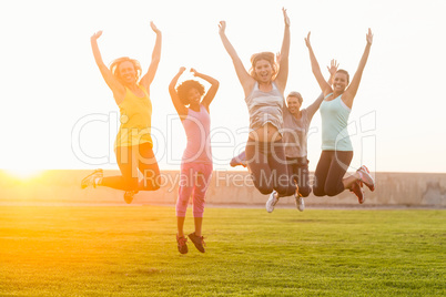 Happy sporty women jumping during fitness class