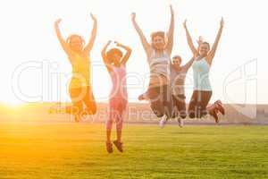 Happy sporty women jumping during fitness class