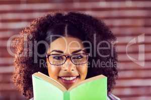 Attractive smiling hipster holding book