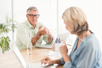 Casual business team discussing together Casual business team discussing together