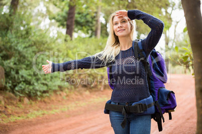 Pretty hitchhiker sticking thumb out