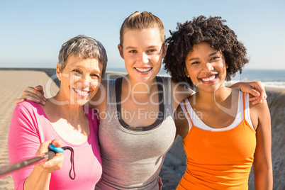 Smiling sporty women taking selfies with selfiestick