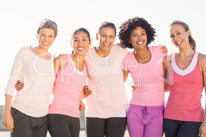 Smiling women wearing pink for breast cancer