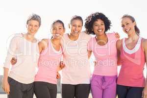 Smiling women wearing pink for breast cancer