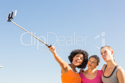 Sporty women posing and taking selfies with selfiestick