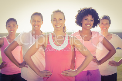 Smiling women wearing pink for breast cancer and posing