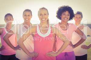 Smiling women wearing pink for breast cancer and posing