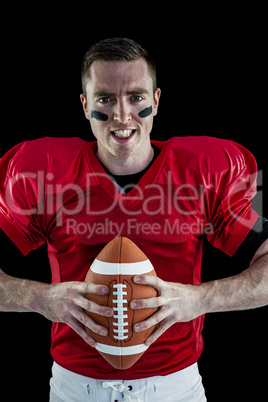 American football player holding a ball