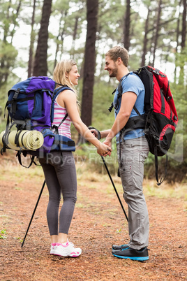 Young happy hiker couple looking at each other