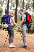 Young happy hiker couple looking at each other