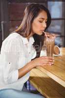 A beautiful woman drinking a hot chocolate