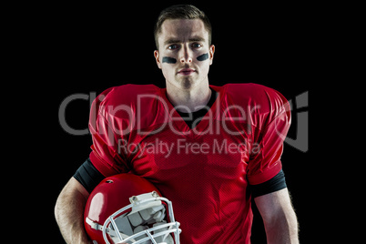 A serious american football player looking at camera