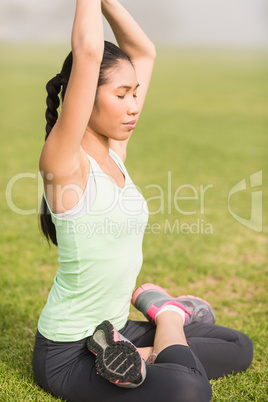 Peaceful sporty woman doing the lotus pose