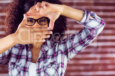 Attractive hipster taking picture with hands