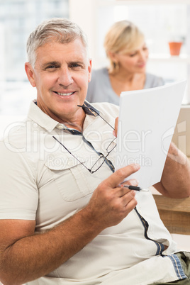 Smiling businessman reading a document