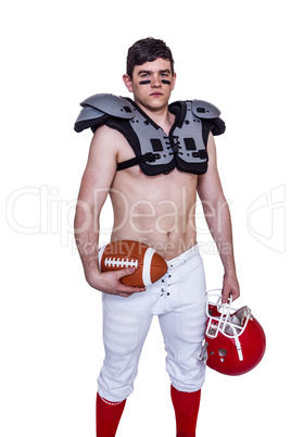 American football player holding a ball and helmet