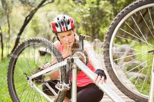 Blonde athlete checking her mountain bike