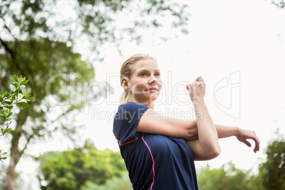 Athletic woman doing arms stretching