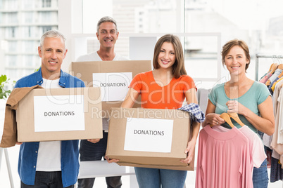 Smiling casual business people with donation boxes